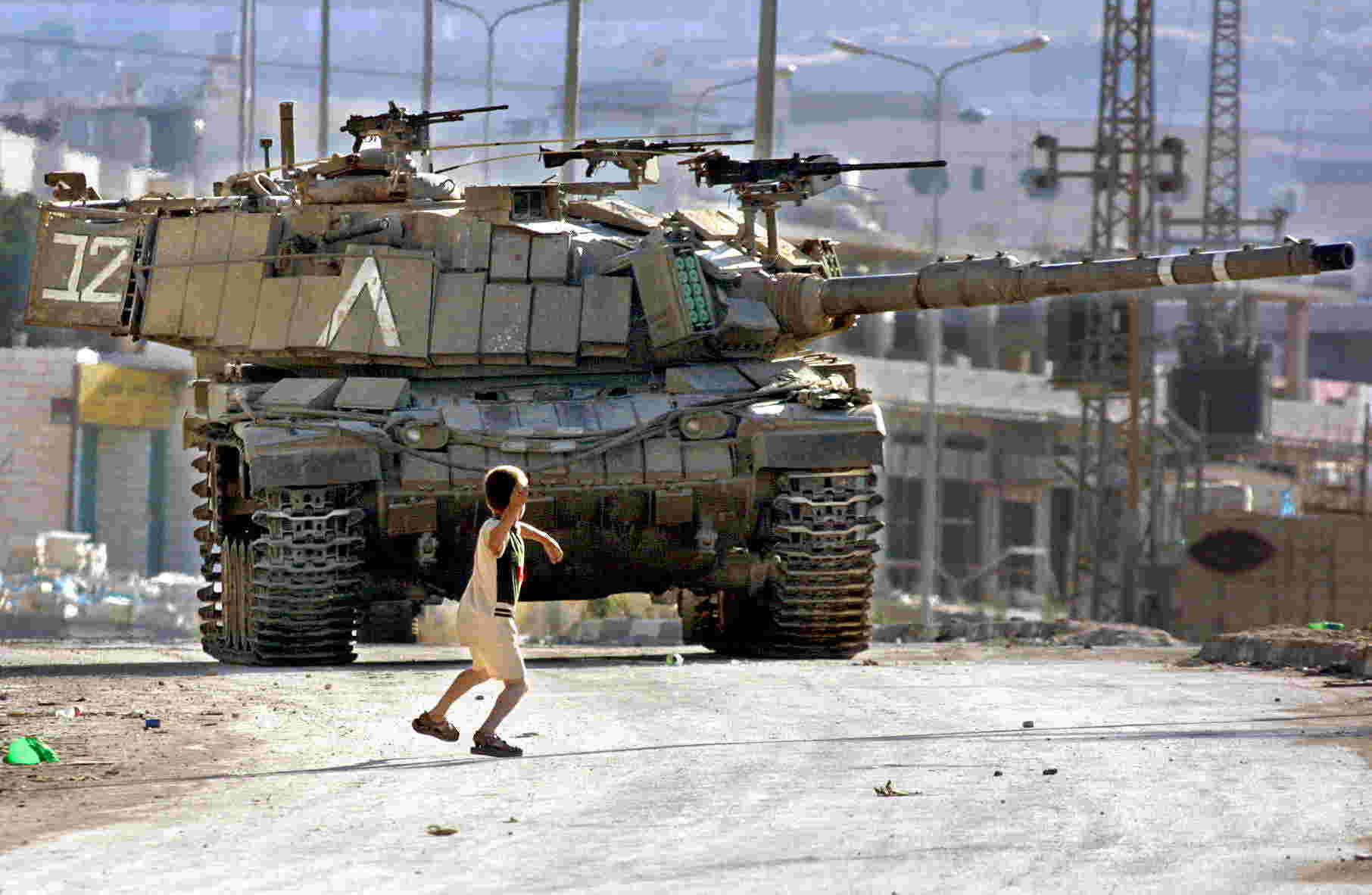 Palestinian child stoning Israeli tank