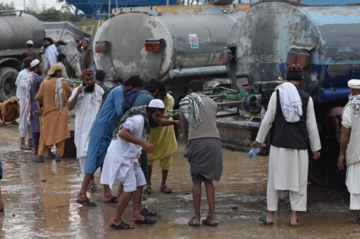 Water stands at the H-9 protest venue and the road adjacent to it.  Photos by Tanveer Shahzad and Kashif Abbasi